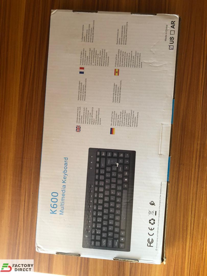 Back View of HP K600 Multimedia Keyboard box showing compact black layout and multimedia icons.